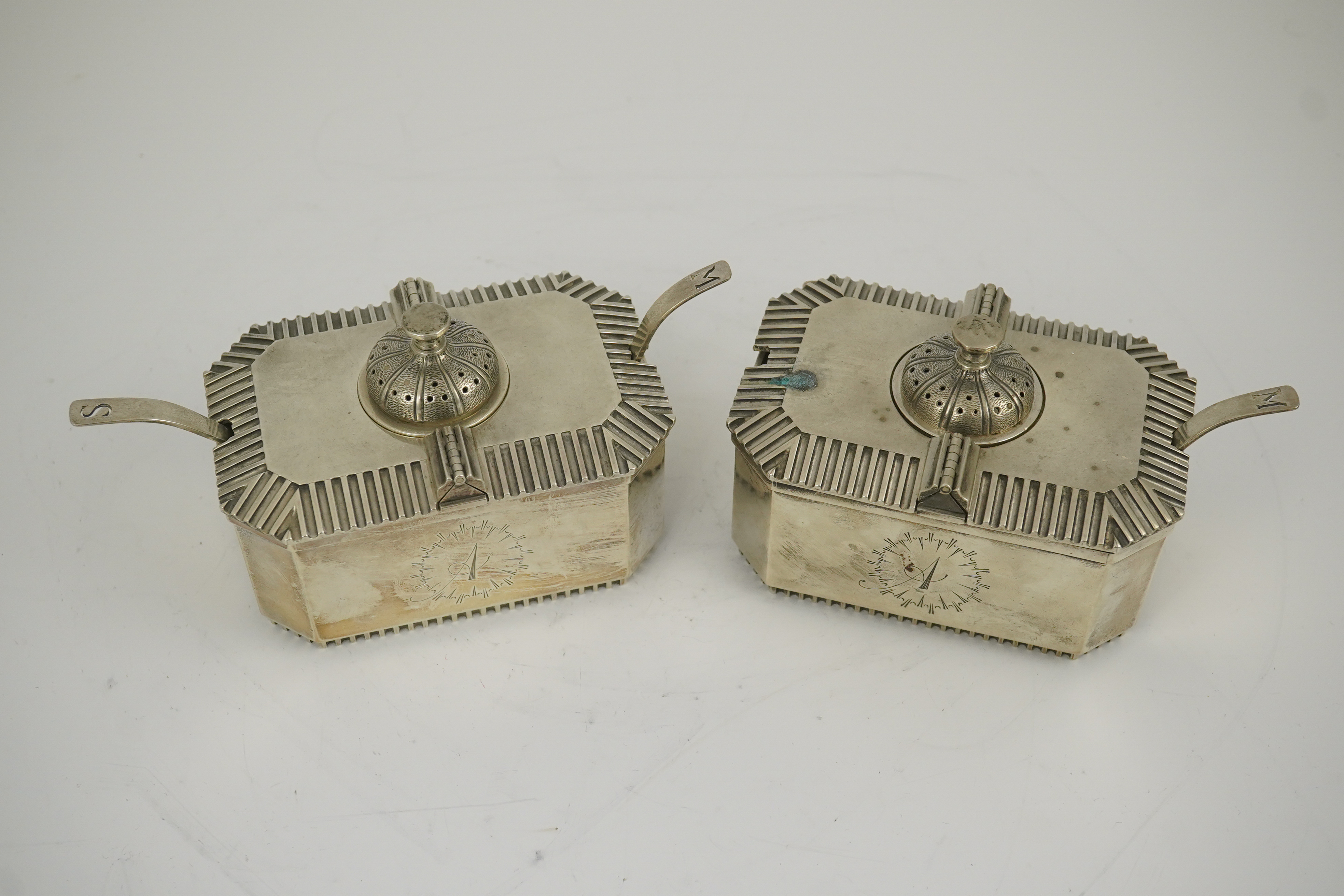 A pair of Elizabeth II silver double lidded condiments and matching spoons, by Hennell, Frazer & Haws